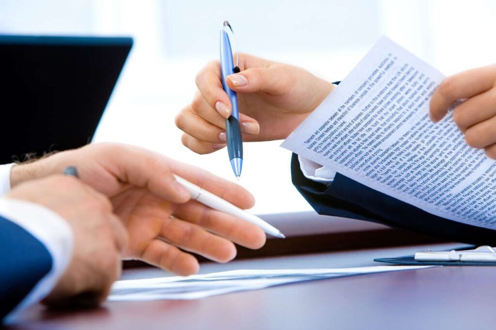 Two people having a discussion with paper and pen