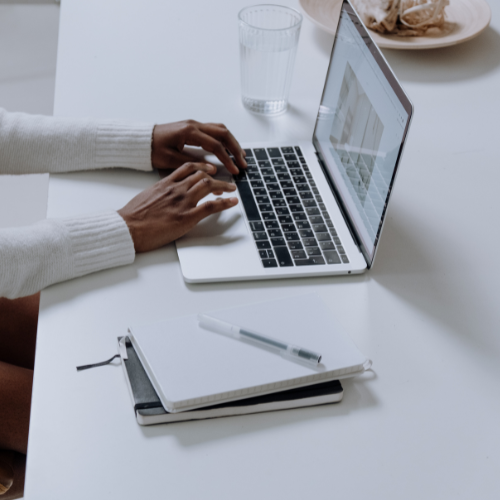 A person browsing and typing on laptop